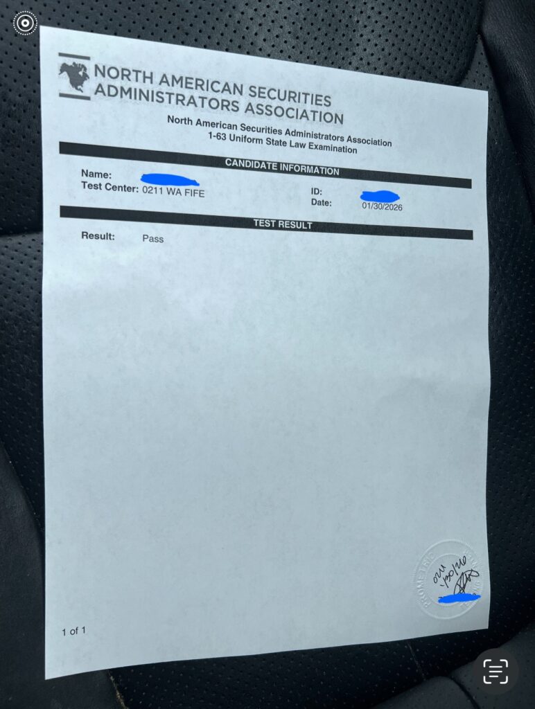 Printed Series 63 exam result sheet showing a passing result for the 1-63 exam, photographed in hand, with personal details covered for privacy.